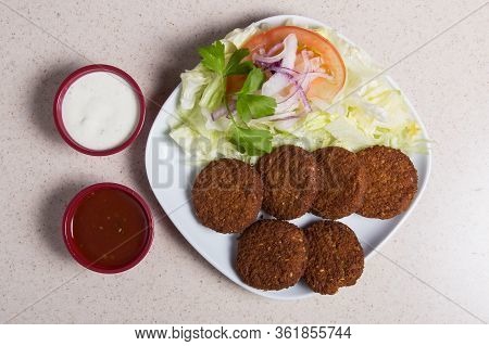 Near-eastern Dish Called Falafel With Salad In A White Dish