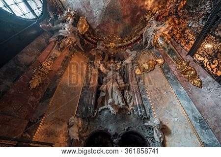 Feb 2, 2020 - Munich, Germany: St Peter Petrus Statue With Two Angels On Top In Entrance Hall To Bar