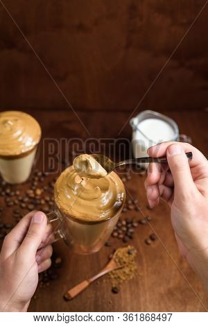 Cold Dalgon Coffee In Clear Glasses On A Dark Wooden Background. Foam From Sugar And Instant Coffee