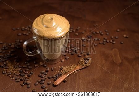 Cold Dalgon Coffee In Clear Glasses On A Dark Wooden Background. Foam From Sugar And Instant Coffee