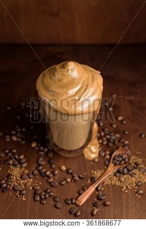 Cold Dalgon Coffee In Clear Glasses On A Dark Wooden Background. Foam From Sugar And Instant Coffee