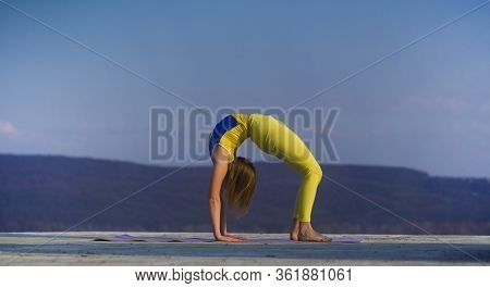 Young Gymnast Girl Perform Various Gymnastic And Yoga Exercises, Including Splits And Bending Over B
