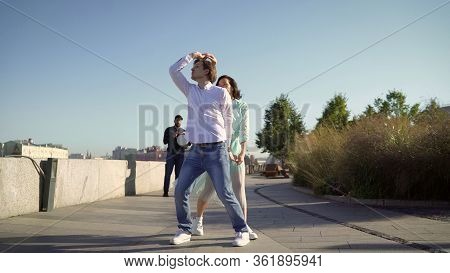 A Young Couple Dancing A Spanish Dance To Live Music. Young Couple Dancing Outdoors Under The Button