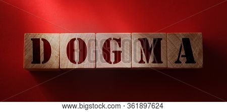 Dogma Word Made With Wooden Letters On Red Background. Beliefs Psychology Concept