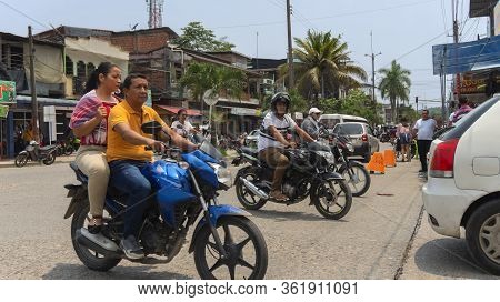 La Hormiga, Putumayo / Colombia - March 8 2020: People Riding A Motorcycle On A Congested Street In 