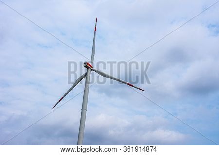 Windmill With The Red Stripes On A Cloudy Day