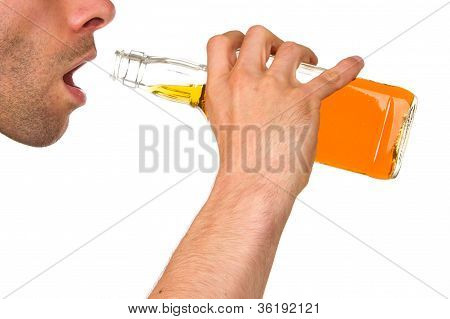 Man Drinking Alcohol Out Of A Bottle