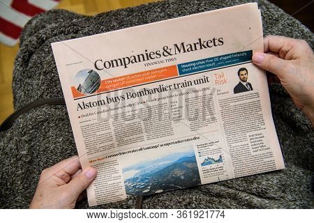 Paris, France - Feb 19, 2020: Pov Of Senior Hands Holding Latest Financial Times Newspaper Featuring
