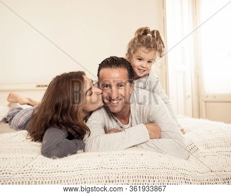 Covid-19 Quarantine. Happy Loving Family Lying In Bed Staying At Home During Coronavirus Outbreak