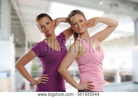 Young women steaching and workingout inside a building