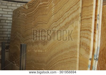 A Pile Of Large Slabs Of Natural Stone Called Onice Cappucino