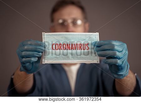 Covid-19. Doctor Or Nurse Holding Face Surgical Mask. Stop The Virus Spread, Protect Yourself And Ot