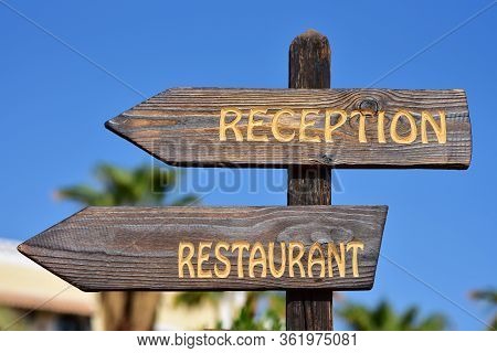 Reception And Rastaurant Inscription On A Wooden Sign On The Hotel Premises.