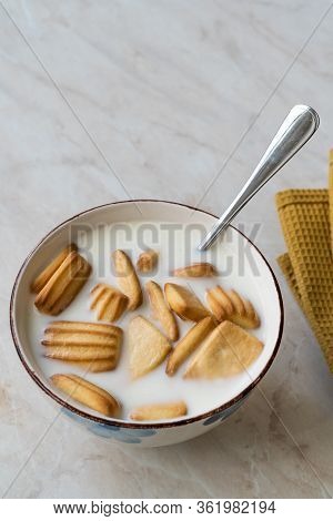 Baby Biscuits With Milk In Bowl Also For Theeting.