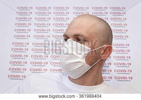 Coronavirus. Convid-19. A Sick Medical Patient Wears A Face Mask With Covid-19 Coronavirus Text At W