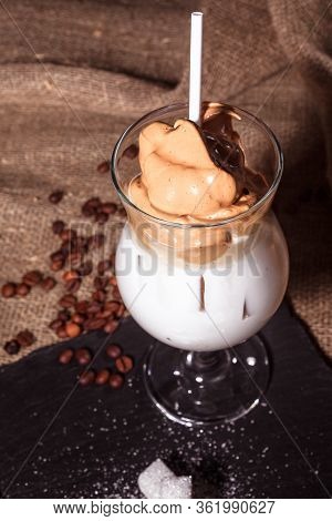 Cold Trendy Drink Korean Dalgon Iced Coffee On A Dark Background. Delicious And Popular Coffee In Th