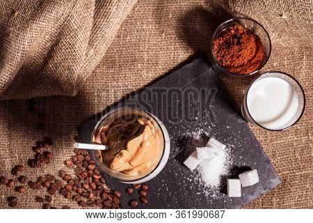 Cold Trendy Drink Korean Dalgon Iced Coffee On Dark Background. Delicious And Popular Coffee In The