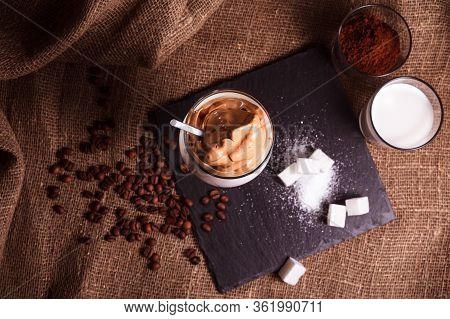 Dalgona Coffee With Milk Whipped With Foam, Korean Trend Home-made Coffee. Black Stone Stand, Sugar