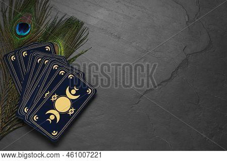 Tarot Cards, Peacock Feathers And Space For Text On Black Table, Flat Lay. Reverse Side