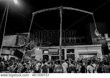 Howrah, West Bengal,india - 15th April 2019: Two Hindu Devotees Are Hanging From Pole In Air, At Nig