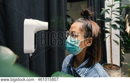 The Asian Tourist Woman Has Checked Body Temperature With A Thermal Temperature Scanner Detector, Ne