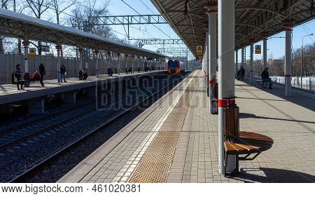 April 9, 2018, Moscow, Russia. Passengers On The Railway Platform Waiting For The Lastochka Train.