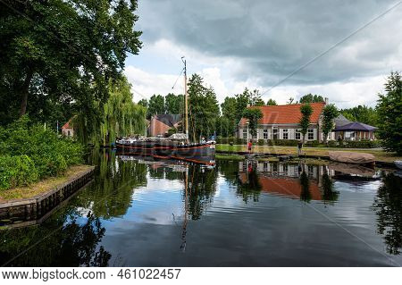 Hasselt, Overijssel, The Netherlands - 07 20 2022 - Reflecting Historical Houses In The River