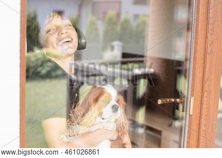 Emotional, Satisfied, Laughing And Delightful Teenager With Coker Spaniel Dog Cavalier King Charles 