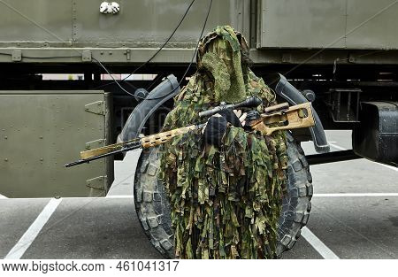 Close-up Portrait Of A Military Sniper In Camouflage Green Army Clothes With A Degtyarev Sniper Rifl