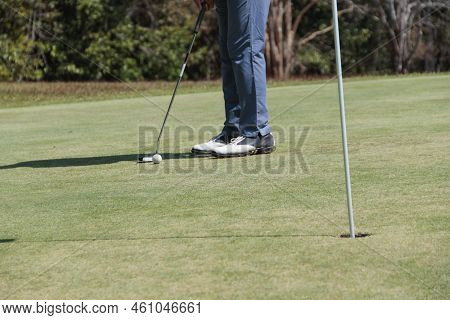Golfers Are Putting Golf In The Evening Golf Course Golf Backglound. Golfer Hitting Golf Ball. Sport