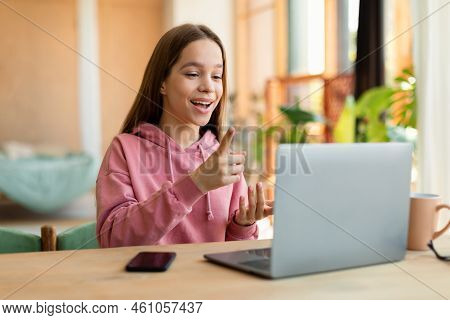 Smart Girl Teenager Having Video Conference With Teacher From Home, Using Laptop And Talking At Webc