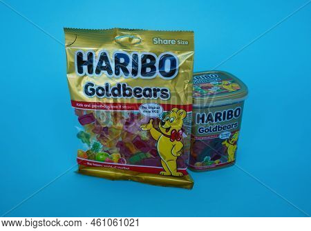 Pskov, Rusia - August 09, 2022: Two Packs Of Sweet Haribo Chewing Bears On A Blue Background. Differ