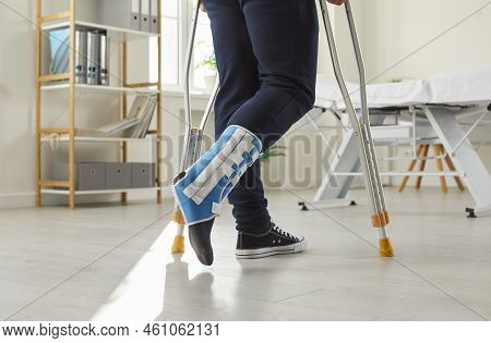 Injured Man With Bandage On Broken Leg Walk On Crutches