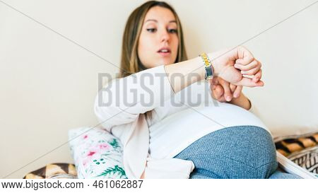 Pregnancy Contractions Time. Childbirth Time, Contractions Pain. Pregnant Holding Baby Belly, Woman 