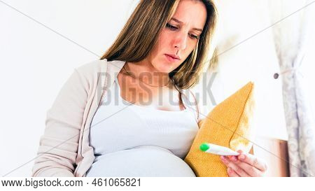 Pregnancy Health Temperature Check. Pregnant Woman Holding Thermometer, Check Fever Flu Temperature.