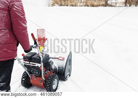 Detail Of Portable Red Snow Blower Powered By Gasoline In Action. Man Outdoor Using Snowblower Machi