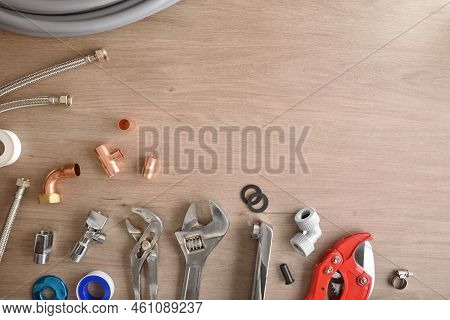 Row Of Plumbing Materials And Tools On Wooden Workbench Top View Background. Top View. Horizontal Co