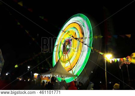 Ferris Wheel At Night Festival In Slow Motion Photo. High Roller