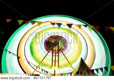 Ferris Wheel At Night Festival In Slow Motion Photo. High Roller