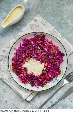 Coleslaw Salad Of Red Cabbage And Carrots With Mayonnaise Dressing In A White Bowl On A Gray Concret