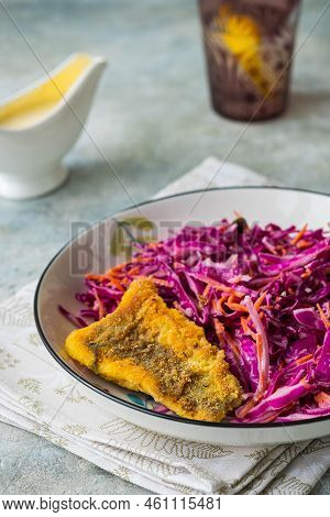 Grilled Fish With Red Cabbage And Carrot Colslow Salad With Mayonnaise Dressing In A White Bowl On A