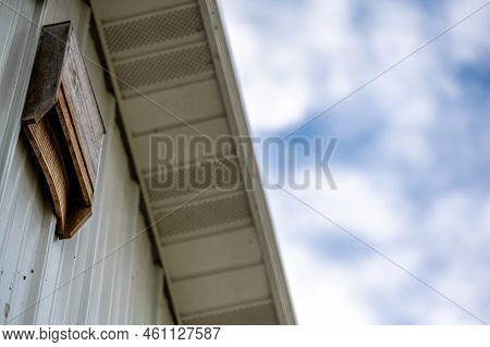 Wooden Bat House On White Corrugated Tin Barn