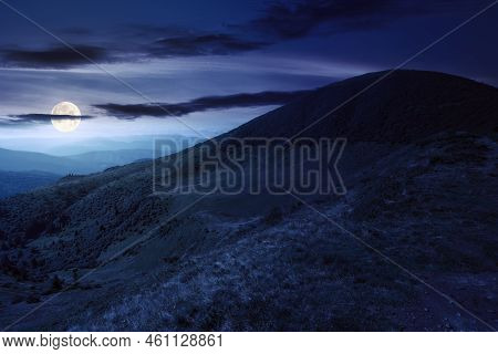 View In To The Mountain Valley At Night. Beautiful Summer Landscape Of Trascarpathia With Forested H