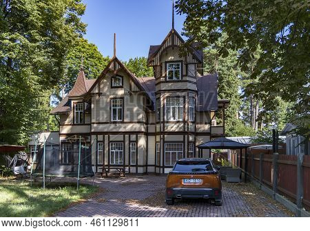 Latvia, Jurmala, August, 2022 - Exterior View Ancient Renovation Wooden Home With Turrets In Jurmala