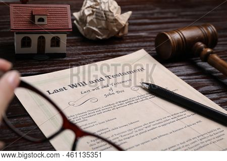Last Will And Testament Near House Model And Gavel On Wooden Table, Closeup