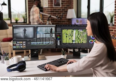 Asian Freelancer Editing Audio Film Montage With Post Production Software On Computer. Videographer 