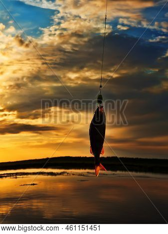 Fishing At Sunset. Catching Predatory Fish On Spinning. Sunset Colors On The Water Surface, Sunny Pa