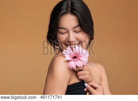 Merry Young Asian Female Virgin Smiling With Closed Eyes And Touching Shoulder With Fresh Gerbera Fl