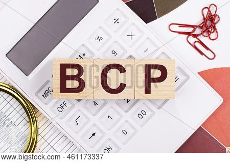 Flat Lay, Top View Of Office Desk. Workplace With White Calculator, Magnifying Glass, Red Paper Clip