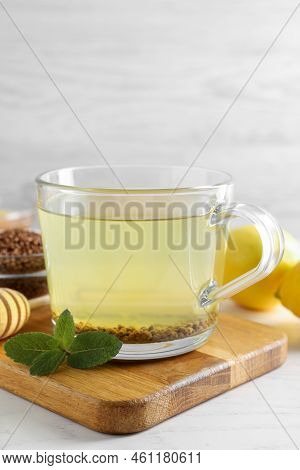 Cup Of Aromatic Buckwheat Tea, Mint And Granules White On Table, Closeup
